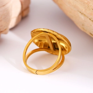 Detailed macro view of gold-plated stainless steel ring with elegant shell texture