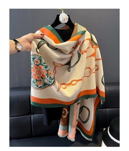 Close-up of khaki cashmere-feel scarf with orange floral pattern and soft fringe edges