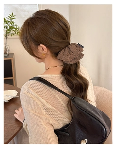 Brown knit scrunchie with lace edge and Blind For Love label used for low ponytail