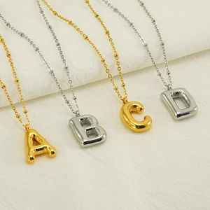 Macro detail of 3D bubble balloon alphabet pendants A B C D on bead chains