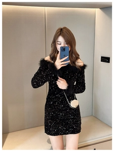 Close-up of black sequined off-shoulder dress featuring luxurious feather trim on cuffs
