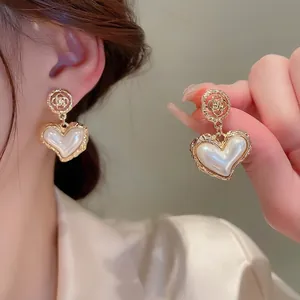 Vintage gold hollow rose earrings with heart pearl pendants for elegant women