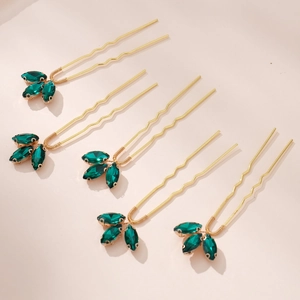 Set of five gold U-shaped bridal hair pins with elegant green crystal leaf clusters