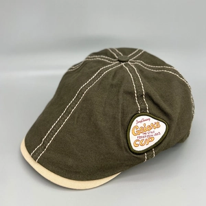 Vintage olive green newsboy cap with contrast beige brim and retro circular side embroidery