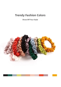 Close-up of assorted colorful 22mm silk scrunchies with elegant pleated satin texture