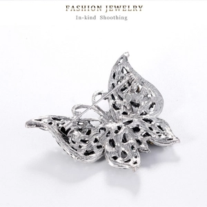 Vintage silver butterfly brooch with rhinestone inlay and hollow mesh design