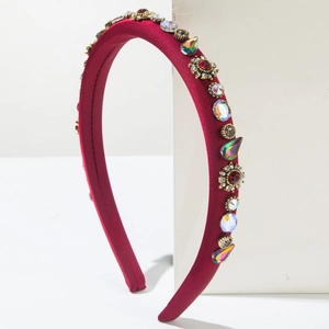 Macro detail of wine red satin headband with colorful rhinestones and gold alloy settings