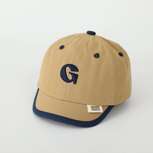 Detail of khaki kids baseball cap with navy blue G embroidery and soft short brim
