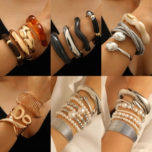 Chunky gold and silver bracelets set with pearls and resin accents for women