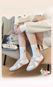 Detail of cream dog cake embroidery on comfortable ribbed cotton crew socks for women