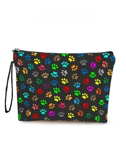 Detail view of durable canvas makeup bag with colorful paw prints and black zipper closure