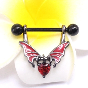 Macro shot of wing-shaped nipple shield with red heart stone and black coated bar