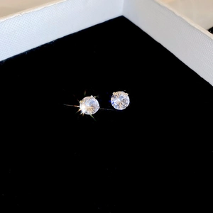 Macro shot of silver stud earrings with sparkling cubic zirconia in a jewelry box