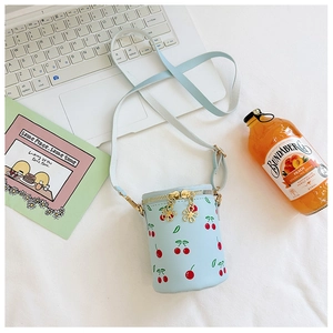 Top view of a light blue bucket bag with cherry print and flower-shaped zipper detail