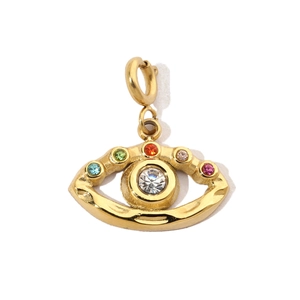 Macro shot of gold evil eye pendant with vibrant multicolored rhinestones and central diamond