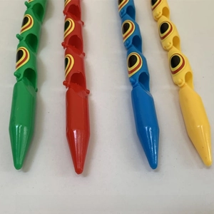 Close-up of four colorful articulated plastic toy snakes with movable joints for children