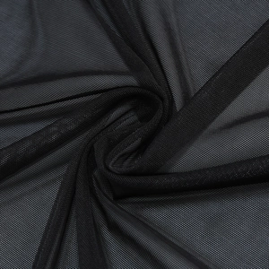Detail of black fine mesh fabric with semi-transparent texture and whirlpool layering
