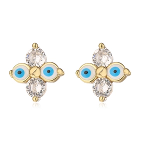Close-up of gold cross star earrings featuring sparkling zircons and evil eye details