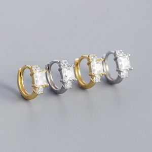 Close-up of square zircon earrings in gold and silver finish with detailed stone setting