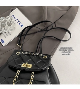Macro shot of black quilted leather backpack featuring gold chain straps and twist lock