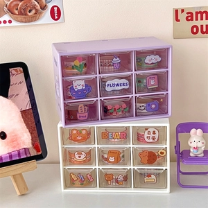 Stacked purple and white desktop organizers with nine clear drawers and cute stickers