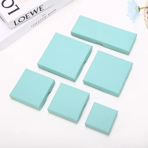 Detail view of light blue textured paper gift boxes in six various rectangular sizes