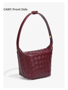 Detail of dark burgundy woven leather texture with a gold metal buckle on side view