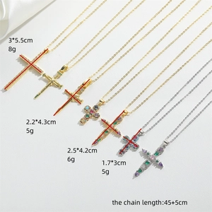 Retro hip-hop cross pendant necklaces in gold and silver finishes on textured background