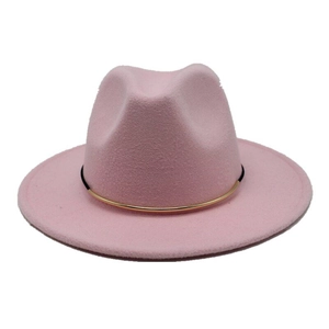 Close-up of pink wide brim fedora hat featuring a black band with gold metal hardware