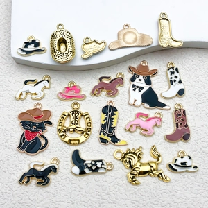 Detailed macro view of western cowboy hat and boot enamel charms for DIY jewelry making