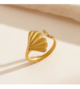 Macro detail of golden ginkgo leaf ring with a matte brushed finish and open adjustable band