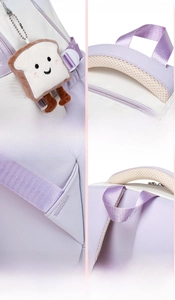 Detail view of reinforced stitching, honeycomb mesh handle and cute bread charm on backpack