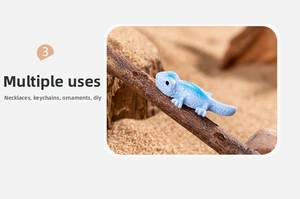 Miniature blue chameleon resin figure on a wood branch for garden decor and DIY crafts