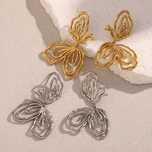 Chic hollow butterfly drop earrings in gold and silver finish on textured stone surface