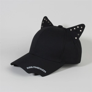 Detail view of black cat ear baseball cap featuring silver pyramid studs and printed brim