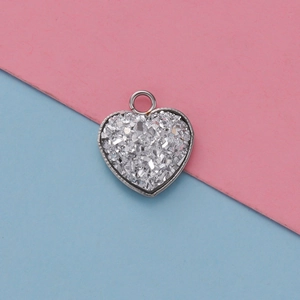 Macro shot of 13mm heart-shaped stainless steel pendant base with white glitter inlay