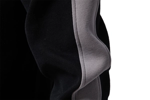 Close-up of knit fabric texture and grey stitching on black casual sweatshirt sleeve