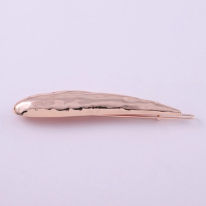 Detailed macro view of the rose gold lava metal texture on this stylish geometric hair clip