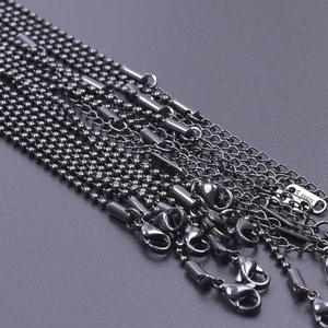 Macro shot of 2mm black stainless steel ball chains and link chains with lobster clasps