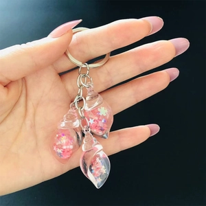 Detail shot of a creative luminous pink shell keychain with stars inside