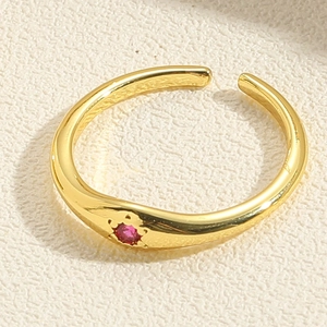 Close-up of double-layer golden open ring featuring a sparkling pink zircon stone