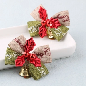 Detail of Christmas bell bows with Merry Christmas printing on ceramic plate