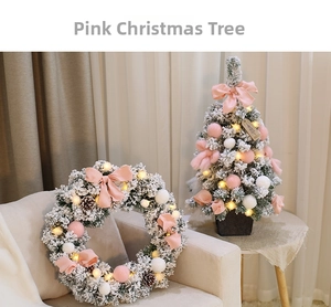 Detail of pink Christmas wreath with velvet bows, pine cones and warm LED lights
