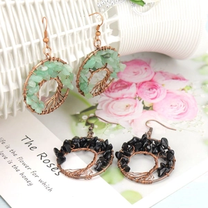 Detail of handmade Tree of Life earrings with green and black natural crystal stones