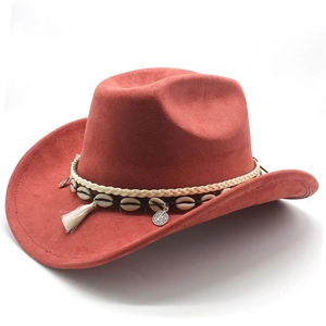 Detail of rust red felt cowboy hat featuring bohemian shell and white tassel band