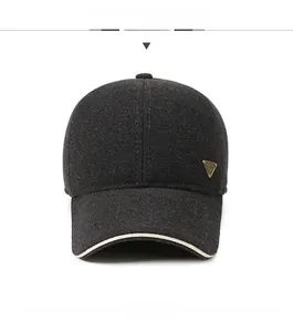 Detailed front view of charcoal grey winter baseball cap with metal logo and contrast brim