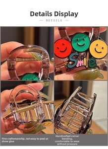 Detail view of smiley hair claw clip with transparent resin finish and strong metal spring