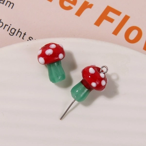 Macro detail of red and green mushroom glass beads for DIY jewelry making and earrings