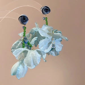 Detailed view of handmade blue fabric flower tassel earrings with intricate petal textures