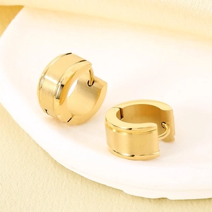 Detail of gold-plated C-shaped earrings with brushed matte and polished dual texture